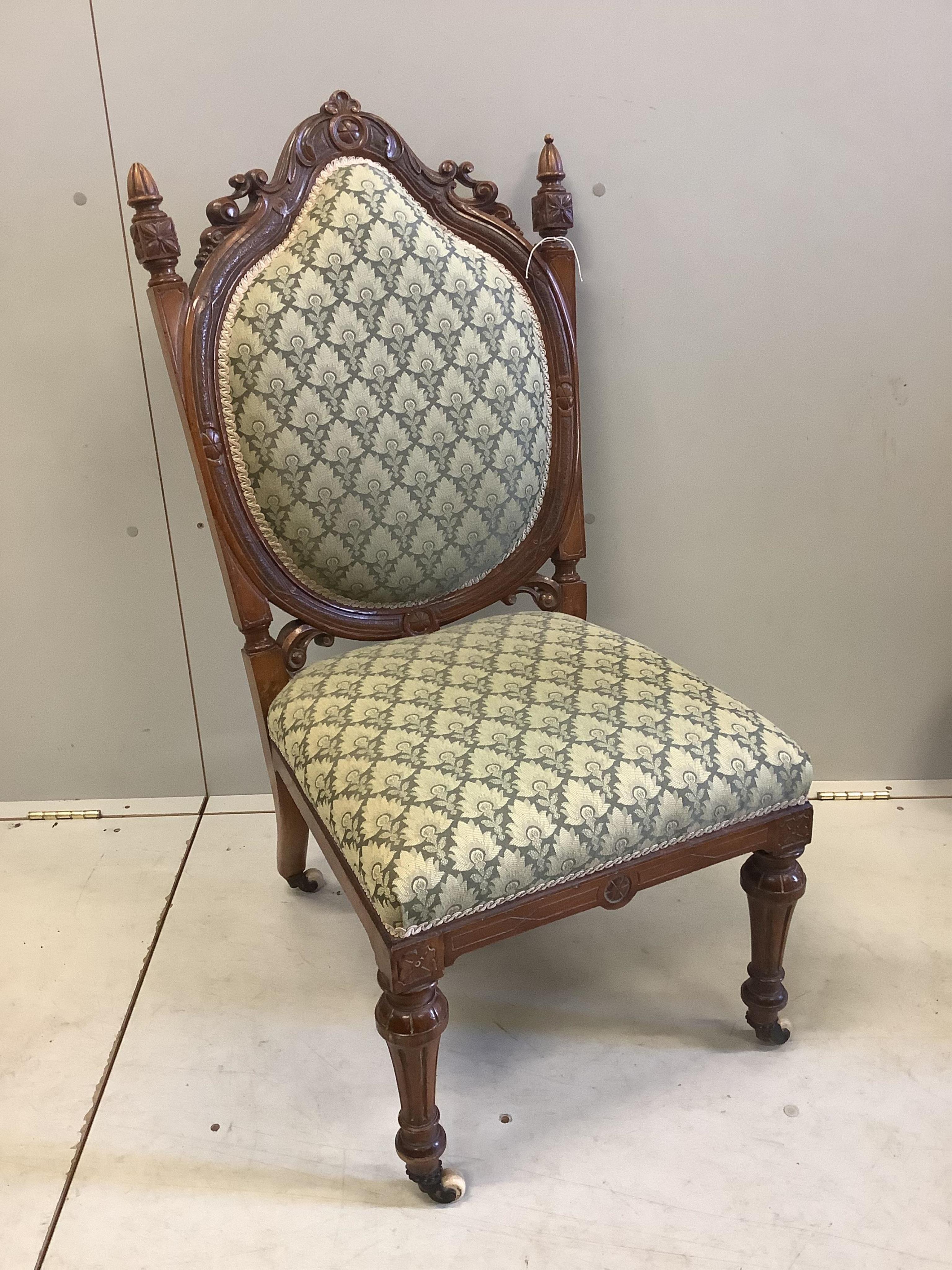A Victorian walnut nursing chair, width 50cm, depth 58cm, height 101cm